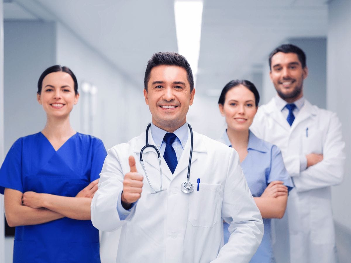 a group of confident and smiling doctors and nurses
