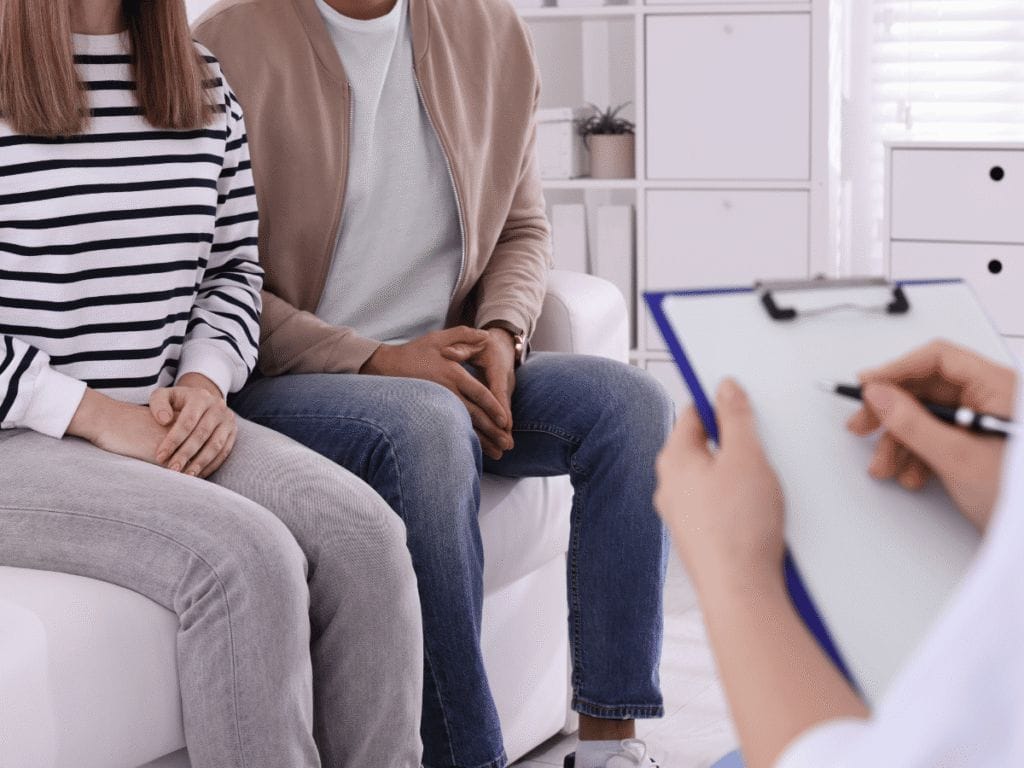 doctor consulting a a couple for sexually transmitted diseases