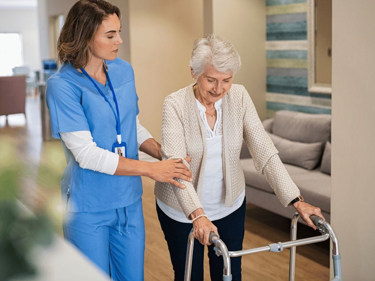 A nurse helping an elder female patient with Osteoporosis