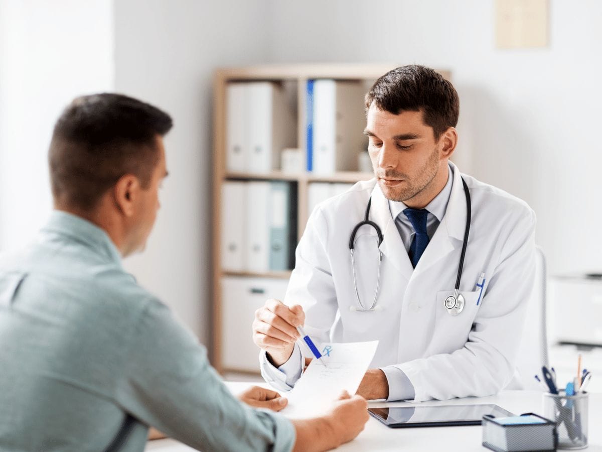 doctor consulting a male patient for HRT Treatment