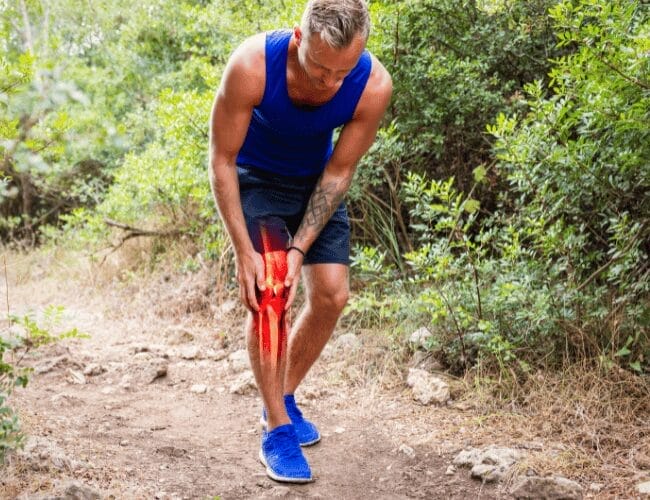 An image of an individual pressing their hand due to pain while walking